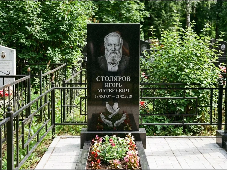 Памятник с гравировкой голубей — гравировка голубя над раскрытыми ладонями внизу стелы, работа «Столяров» в Воронеже